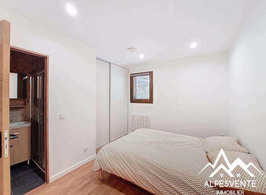 Discover this charming property featuring a cozy bedroom with a comfortable bed and ample natural light.