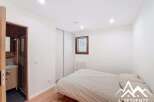 Discover this charming property featuring a cozy bedroom with a comfortable bed and ample natural light.