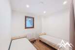 Discover this cozy bedroom featuring two single beds, perfect for a comfortable stay.