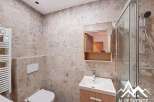 This modern bathroom features a sleek design with neutral tones and high-end finishes.