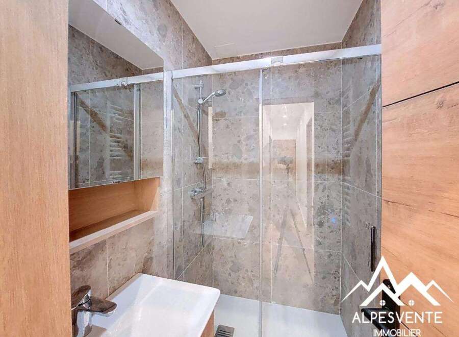 Step into a modern bathroom featuring a sleek glass shower enclosure.