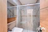 Step into a modern bathroom featuring a sleek glass shower enclosure.