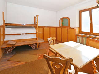 Step into a charming dining space with rustic wooden accents and a cozy atmosphere.