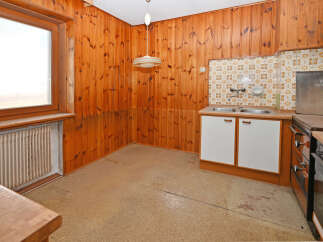 Step back in time with this charming kitchen! Featuring classic wooden paneling and a functional layout, this space offers a unique blend of vintage appeal and practicality.