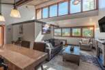 Experience luxury living in this stunning property! This home boasts a spacious living area with large windows, a cozy fireplace, and a modern kitchen.