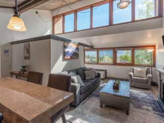 Experience luxury living in this stunning property! This home boasts a spacious living area with large windows, a cozy fireplace, and a modern kitchen.