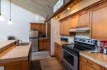 This charming kitchen boasts beautiful wooden cabinetry and a modern stainless steel appliance package.
