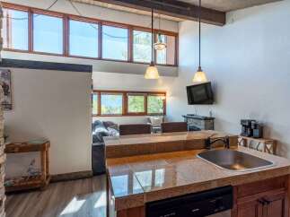 This stunning property boasts a modern kitchen with granite countertops and stainless steel appliances, perfect for culinary enthusiasts.