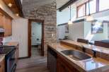 Discover the charm of this stunning kitchen, featuring a beautiful stone accent wall and modern appliances.