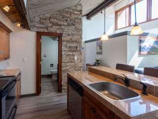Discover the charm of this stunning kitchen, featuring a beautiful stone accent wall and modern appliances.