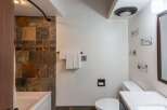 Step into a beautifully designed bathroom featuring a stylish tile shower and a modern vanity.