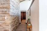 Step into a beautifully designed entryway featuring a stunning stone accent wall that adds a touch of rustic elegance.