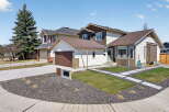 This stunning property boasts a modern exterior with a well-manicured lawn and stylish landscaping.