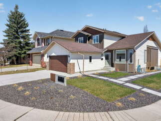 This stunning property boasts a modern exterior with a well-manicured lawn and stylish landscaping.