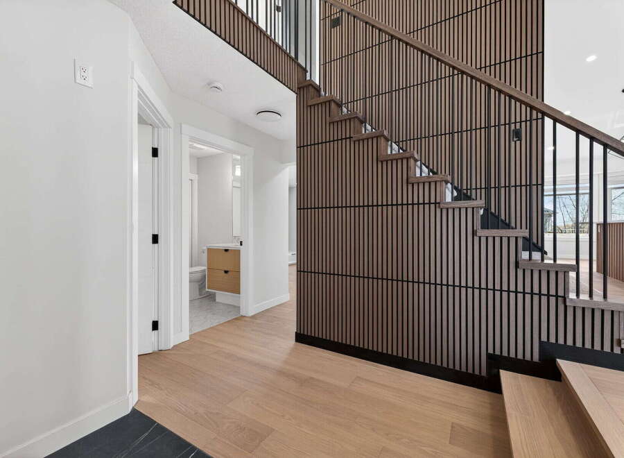 Step into modern elegance with this stunning property featuring a beautifully designed staircase.