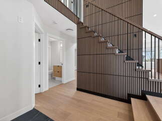 Step into modern elegance with this stunning property featuring a beautifully designed staircase.