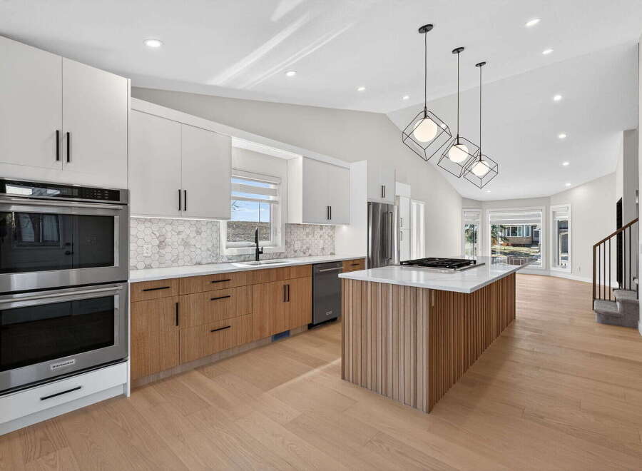 This stunning kitchen boasts modern design with sleek cabinetry and a spacious island.
