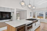 This stunning kitchen boasts a modern design with sleek white cabinetry and a spacious island, perfect for culinary enthusiasts.