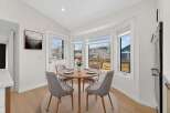 This stunning dining area features a round wooden table, perfect for intimate gatherings.