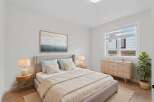 Step into this serene bedroom, featuring a comfortable bed with soft bedding and a calming color palette.