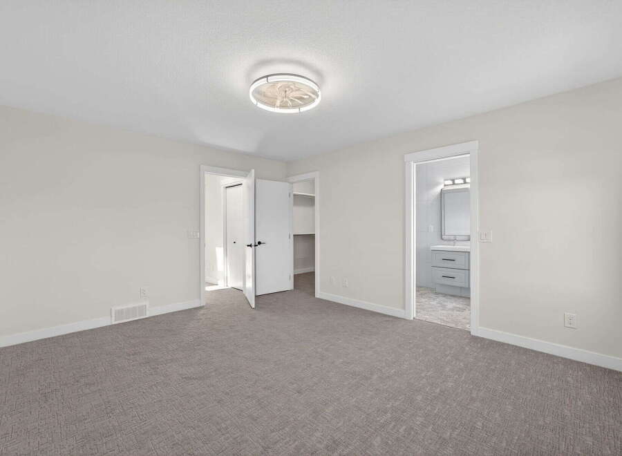 Step into this inviting bedroom, featuring a neutral color palette and ample natural light.