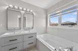 Step into luxury with this stunning bathroom featuring a sleek double vanity and modern design.