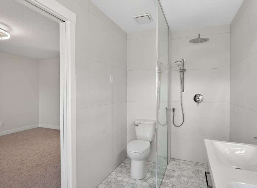 Step into luxury with this stunning bathroom! Featuring a modern design with sleek tile work, a spacious shower, and elegant fixtures, this space is perfect for relaxation.