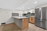 This modern kitchen boasts a sleek design with a spacious island, perfect for meal prep and entertaining.