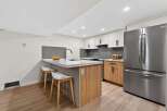 This modern kitchen boasts a sleek design with a spacious island, perfect for meal prep and entertaining.