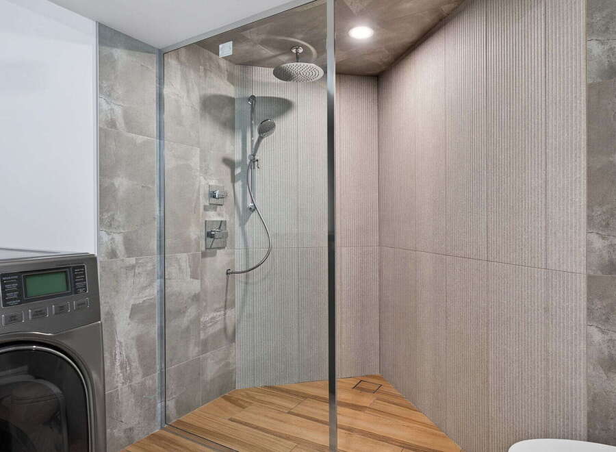 Step into luxury with this stunning bathroom featuring a modern glass shower enclosure.