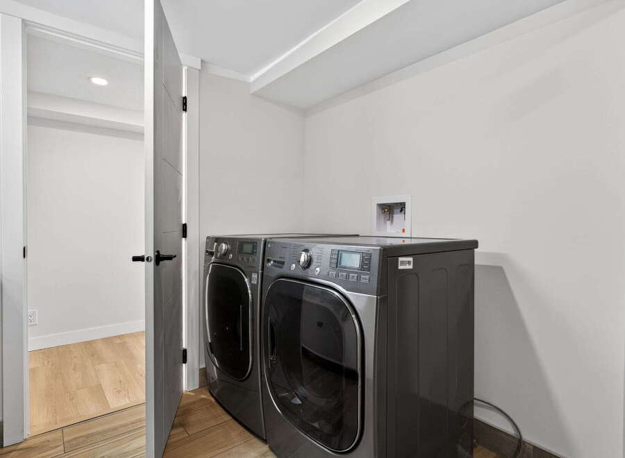 This modern laundry room features a sleek washer and dryer set, perfect for efficient home management.