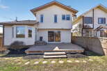This stunning property boasts a spacious backyard with a large wooden deck, perfect for outdoor entertaining.