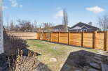 Enjoy the privacy of this beautifully landscaped backyard, complete with a modern wooden fence.