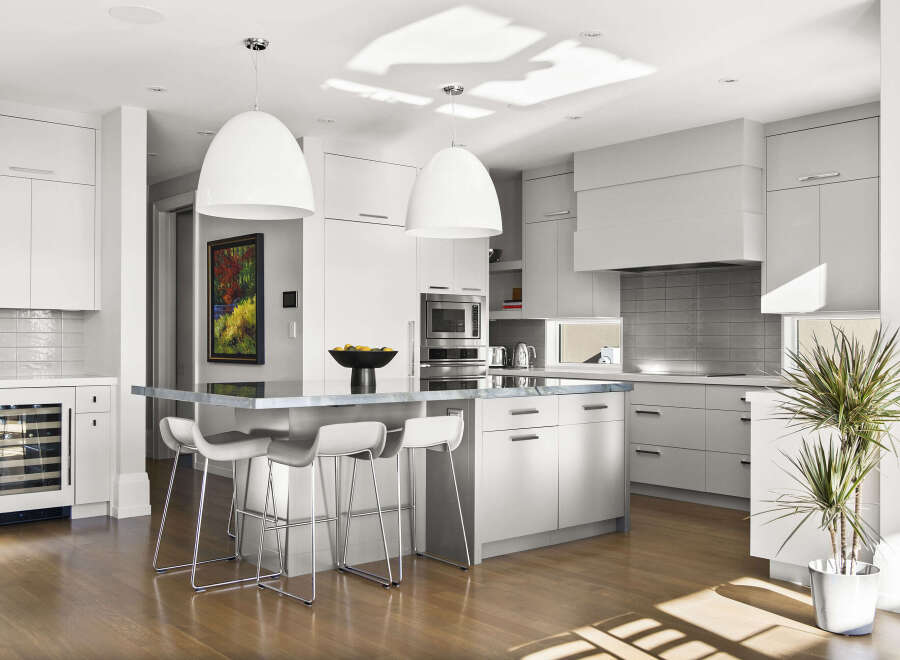 This stunning kitchen boasts a modern design with sleek cabinetry and a spacious island.