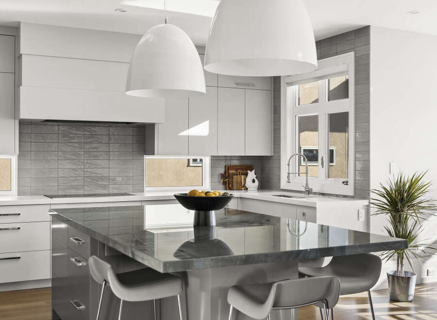 This modern kitchen boasts a sleek design with a large island, perfect for meal prep and entertaining.