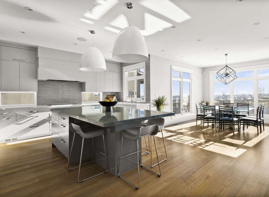 This stunning modern kitchen boasts a sleek design with a large island, perfect for entertaining.