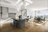 This stunning modern kitchen boasts a sleek design with a large island, perfect for entertaining.