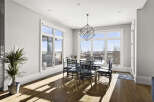 This stunning dining room boasts an abundance of natural light, thanks to the expansive windows that offer breathtaking views.