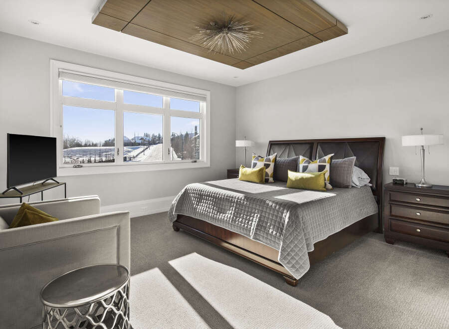 Step into luxury with this stunning bedroom, featuring a modern design and ample natural light.