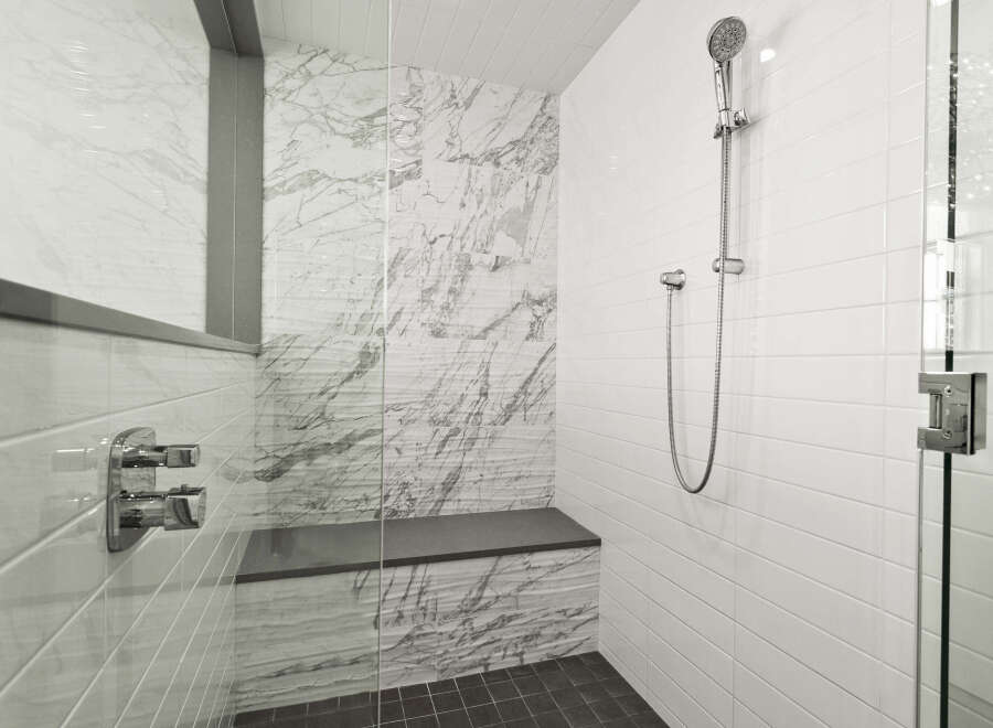 Step into luxury with this stunning bathroom featuring a sleek glass shower enclosure.