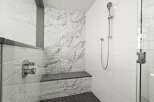 Step into luxury with this stunning bathroom featuring a sleek glass shower enclosure.
