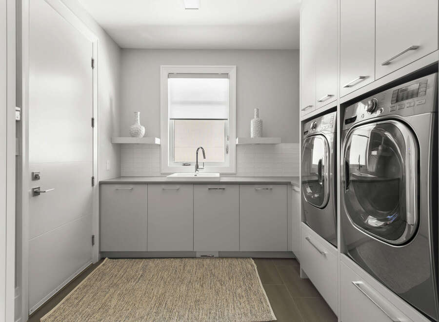 This modern laundry room boasts sleek, minimalist design with ample storage and functionality.
