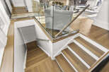This stunning property boasts a modern staircase design, featuring elegant wooden steps and a sleek glass railing.