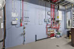 This utility room showcases a complex network of pipes and equipment, essential for a modern home's functionality.