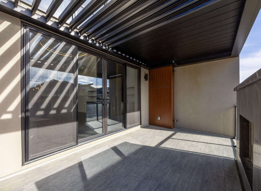 Step into luxury with this stunning outdoor space! Featuring a sleek, modern design, this area boasts a beautiful wooden deck and a stylish pergola, perfect for relaxing or entertaining.