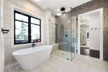 Step into luxury with this stunning bathroom! Featuring a sleek, modern design, this space boasts a freestanding tub, a glass-enclosed shower, and elegant tile work.