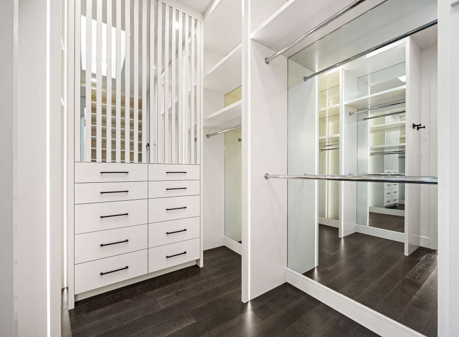 Step into luxury with this stunning walk-in closet, designed for both style and functionality.