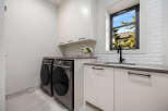 This modern laundry room boasts sleek design and functionality.