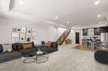 Discover modern living in this stunning property! Featuring a spacious open floor plan, the home boasts a stylish living area with a comfortable sectional sofa and a collection of art.