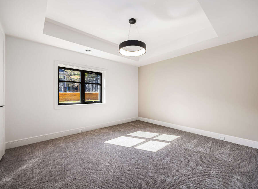 Step into this bright and airy room, featuring a modern design with neutral tones and a plush carpet.